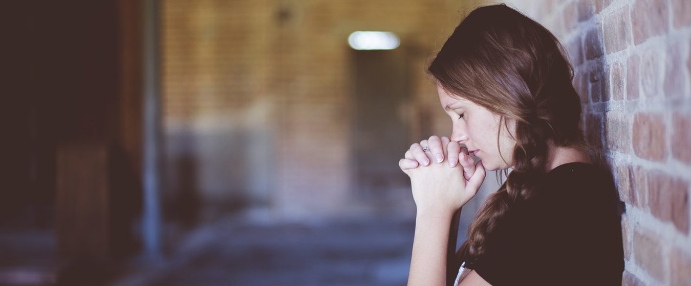 girl standing praying